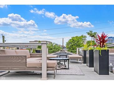 Modern rooftop deck features comfy seating, planters, and city views at 735 Lexington Ave # 7, Indianapolis, IN 46203