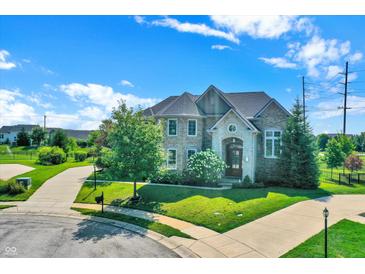 Brick house with a large yard and a circular driveway at 2929 Post Oak Ct, Westfield, IN 46074
