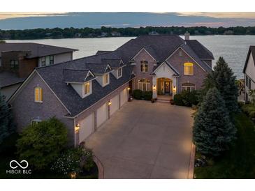 Lakefront property with large brick house and 3-car garage at 9088 Nautical Watch Dr, Indianapolis, IN 46236