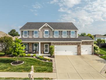 Two-story brick home with two-car garage and manicured lawn at 8816 Blue Marlin Dr, Indianapolis, IN 46239