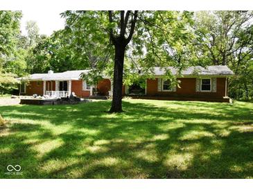 Brick ranch house with large backyard and mature trees at 9100 S Us Highway 35, Muncie, IN 47302