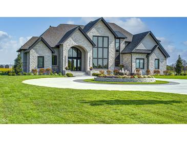 Elegant two-story home with circular driveway and fountain at 9760 Windy Hills Dr, Zionsville, IN 46077
