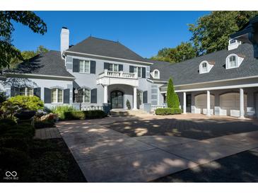 Stunning two-story home with a gray exterior, black shutters, and a large driveway at 8358 Hidden Point Dr, Indianapolis, IN 46256