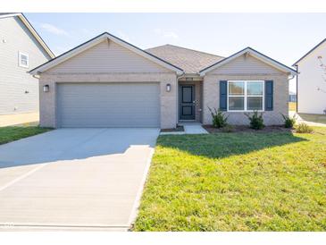 Brick ranch home with gray garage door and landscaped lawn at 6205 Card Blvd, Indianapolis, IN 46221