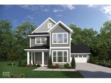 Two-story house with gray siding, brick accents, and a two-car garage at 134 W Franklin St, Shelbyville, IN 46176