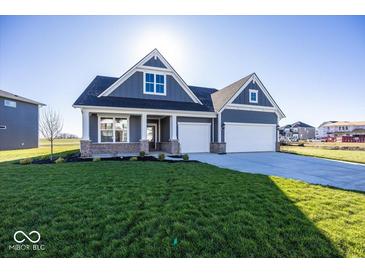 Two-story house with gray siding, brick accents, and a two-car garage at 6425 Ambassador Dr, Plainfield, IN 46168