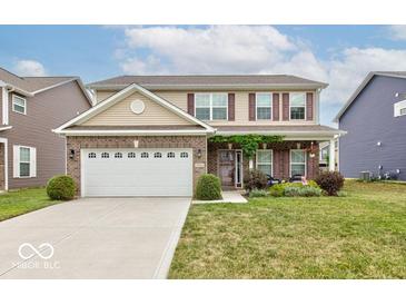 Two story house with brick facade, large windows, and a two car garage at 1558 Wedgewood Pl, Avon, IN 46123