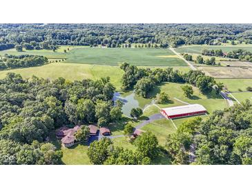 Aerial view of property showing home, pond, and outbuildings at 7601 S 700 W, Morgantown, IN 46160