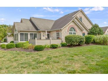 Stone and shingle ranch home with landscaped lawn and private patio at 16948 Maple Springs Way, Westfield, IN 46074