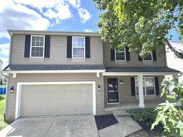 Two story house with neutral exterior and a double garage at 6558 Caressa Way, Indianapolis, IN 46259