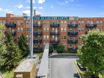 Brick building with balconies and parking at 55 S Harding St # 101, Indianapolis, IN 46222