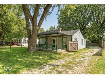 Quaint house with green porch and mature landscaping at 3649 N Sadlier Dr, Indianapolis, IN 46226