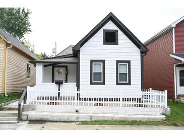 White house with black accents and white picket fence at 25 E Caven St, Indianapolis, IN 46225