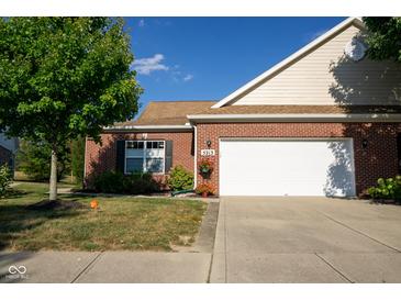 Brick ranch house with a white garage door and landscaping at 5213 Dunewood Way, Avon, IN 46123