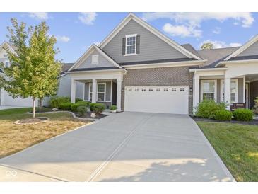 Gray and brick two-story home with white garage door at 17084 Cole Evans Dr, Noblesville, IN 46060