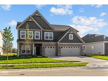 Two-story house with gray siding, a brick base, and a three-car garage at 16890 Silo Ridge Way, Noblesville, IN 46060