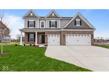 Two-story home with brick and siding, three-car garage, and landscaped lawn at 4959 Amber Crest Dr, Brownsburg, IN 46112