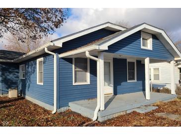 Charming blue house with a covered porch and well-maintained landscaping at 364 Laclede St, Indianapolis, IN 46241