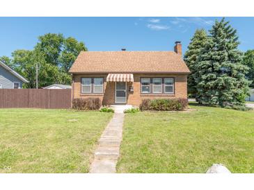 Brick house with brown awning, landscaping, and walkway at 532 E Mills Ave, Indianapolis, IN 46227