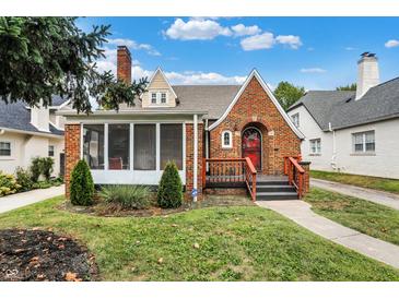 Brick home with screened porch, landscaping, and a walkway at 340 Blue Ridge Rd, Indianapolis, IN 46208