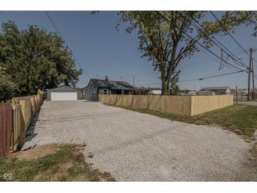 Newly renovated home with gravel driveway and wooden fence at 3730 Prospect St, Indianapolis, IN 46203