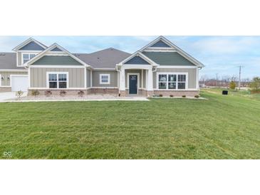 Charming two-story home with a green and white exterior and a lush green lawn at 6210 Fairview Dr, McCordsville, IN 46055