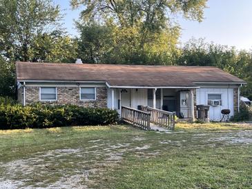 Brick ranch home with a ramp and mature landscaping at 6602 Lennington Dr, Indianapolis, IN 46226