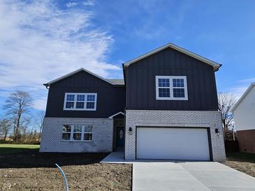 Two-story home with gray siding and white brick accents at 525 Schmitt Rd, Indianapolis, IN 46239