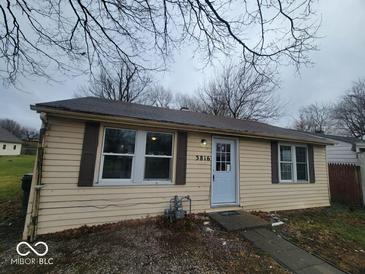 Tan house with new windows and front yard at 3816 St Charles St, Anderson, IN 46013