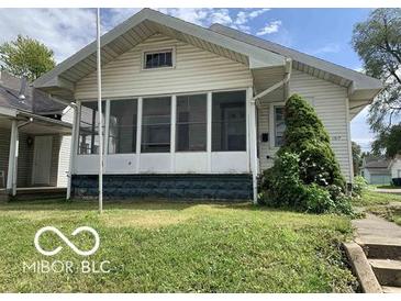 House exterior featuring a front porch and a well-maintained lawn at 1317 W Memorial Dr, Muncie, IN 47302
