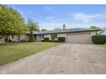 Brick ranch home with attached garage and landscaped lawn at 1061 Saint Paul St, Shelbyville, IN 46176