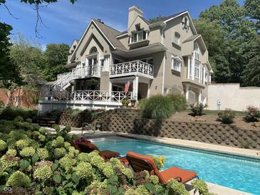 Luxury home with inground pool, lounge chairs, and landscaping at 10781 Cedar Ridge Ln, Brownsburg, IN 46278
