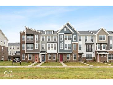 Row of modern townhouses with varied colors and architectural details at 7306 W County Road 600 Rd # 14-602, McCordsville, IN 46055
