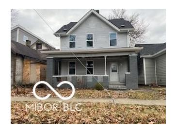 Two story home with gray siding and front porch at 814 S State Ave, Indianapolis, IN 46203