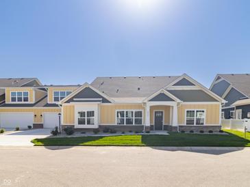 Craftsman style home with gray and yellow siding, two-car garage, and landscaped yard at 4435 W Preserve Pass, New Palestine, IN 46163