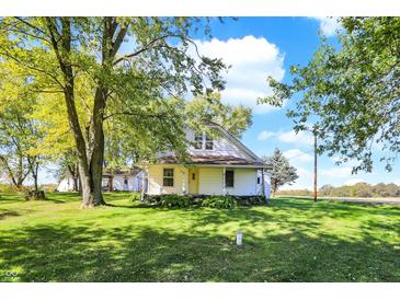 Charming one-story home with a front porch, surrounded by lush greenery at 9490 N 700 E, Indianapolis, IN 46259