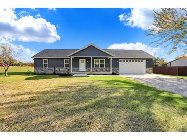 Modern ranch home with stone accents and a two-car garage at 7234 N Christopher Ln, Fairland, IN 46126