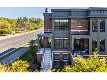 Brick front exterior with gray accents and a porch at 456 Monon Way Dr, Carmel, IN 46032
