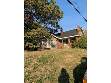 Brick ranch home with a covered porch and mature tree in the front yard at 3132 E 36Th St, Indianapolis, IN 46218