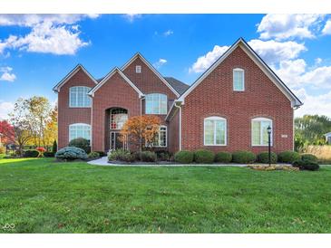 Brick house with a manicured lawn and walkway at 12981 Airhart Blvd, Carmel, IN 46074