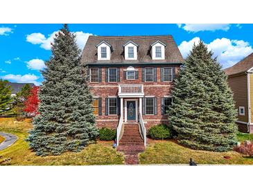 Brick two-story house with landscaping and a walkway at 7178 Lockford N, Avon, IN 46123