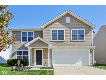 Two-story house with beige siding, white garage door and landscaping at 4633 Angelica Dr, Indianapolis, IN 46237