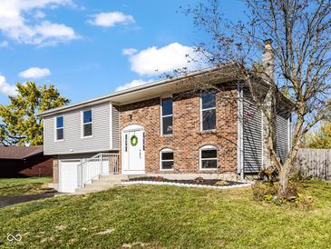 Brick and vinyl-sided home with a two-car garage at 7709 Inverness Dr, Indianapolis, IN 46237