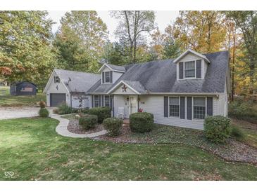 Gray house with gray shutters, a two-car garage and a landscaped lawn at 6971 Lynx Dr, Nineveh, IN 46164