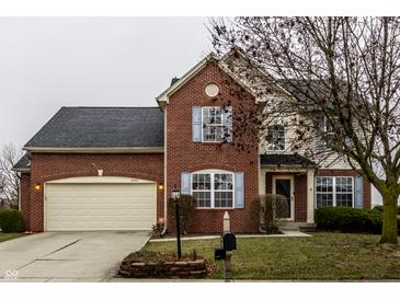 Brick house with two-car garage and landscaping at 19420 Golden Meadow Way, Noblesville, IN 46060