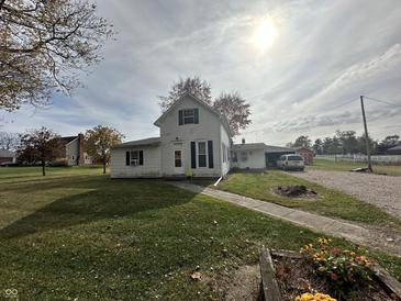 White farmhouse with black shutters, situated on a large lot at 2465 W 100 S, Greenfield, IN 46140