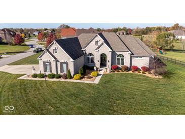 Luxury home with expansive lawn and 3-car garage, situated in a desirable neighborhood at 7610 Monte Carlo Way, Indianapolis, IN 46278