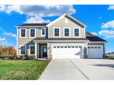 Two-story house with taupe siding, white trim, and a three-car garage at 5856 Fair Oak Cir, Brownsburg, IN 46112