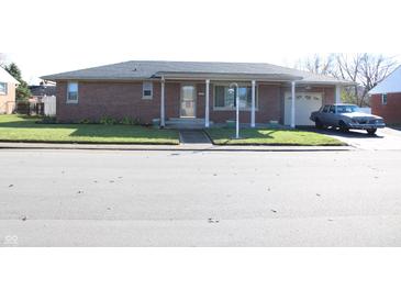 Brick ranch home with attached garage and carport at 409 Dale St, Martinsville, IN 46151