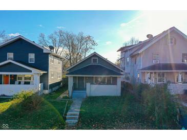 Grey house with white trim, steps, and small front yard at 951 W 33Rd St, Indianapolis, IN 46208